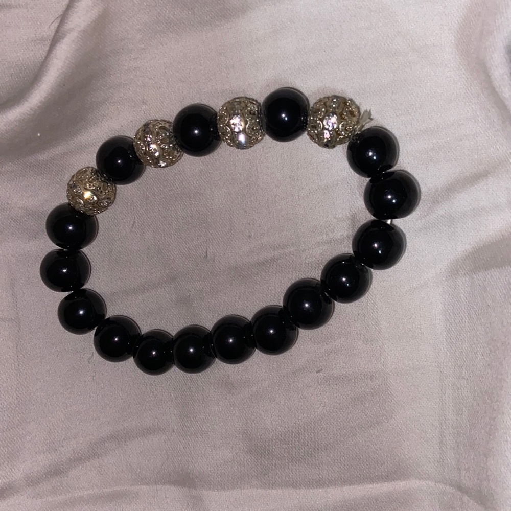 black stretchy bracelet with 4 silver beads
